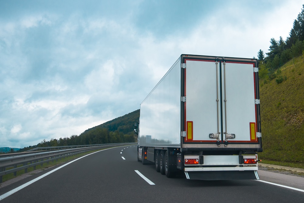 Semi truck with trailer on highway road